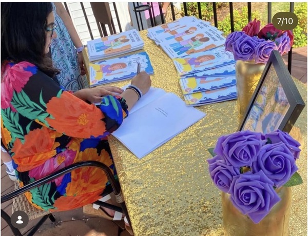 Myra signing books at outdoor event