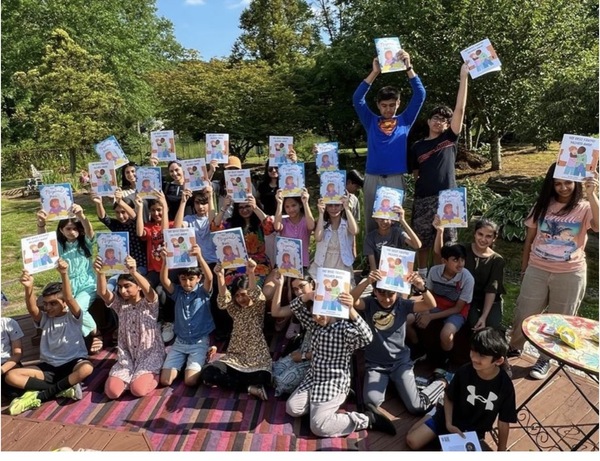 Group of kids holding copies of Myra's books